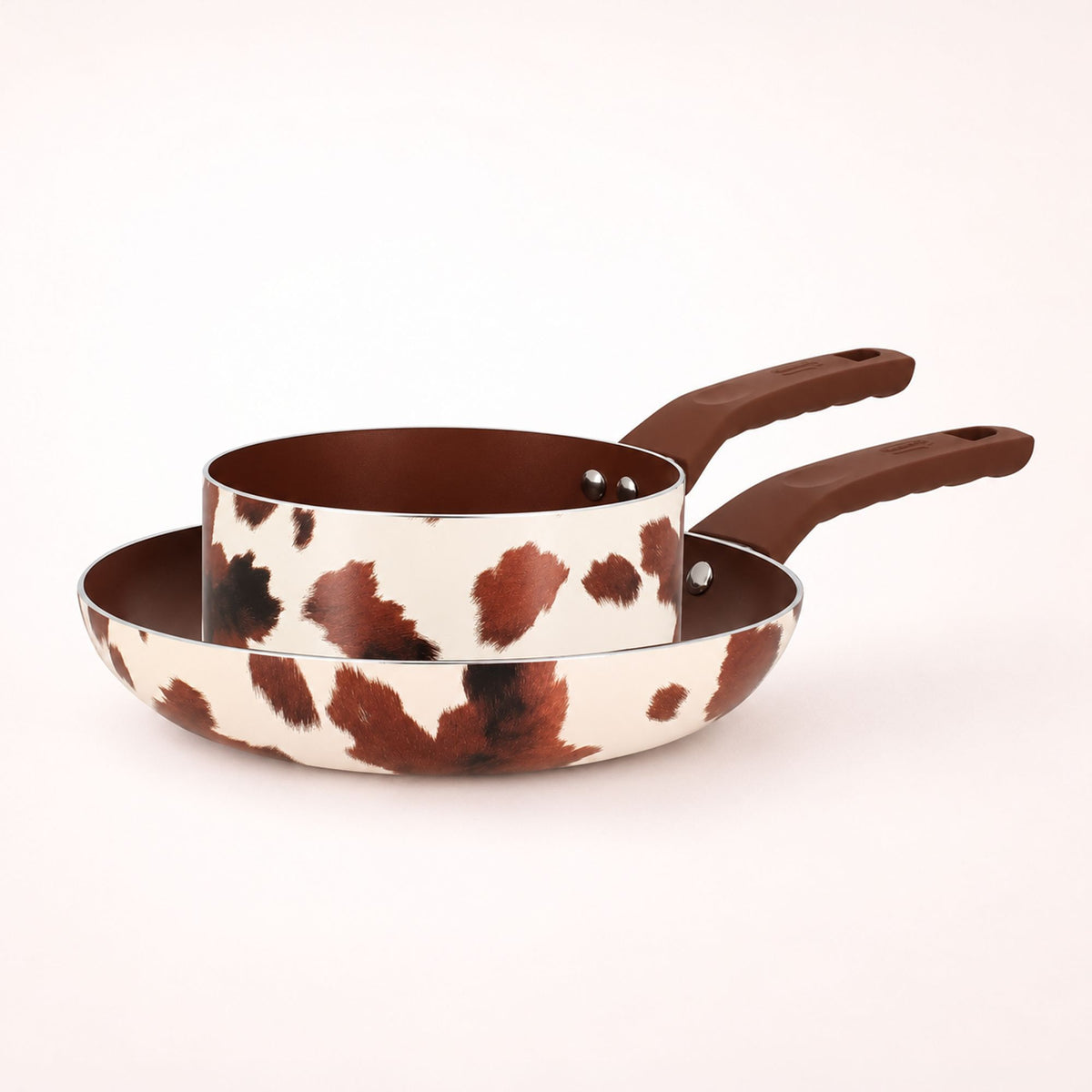 Set de 2 pièces aluminium céramique motif vache, faitout et poêle avec poignées marron sur fond blanc