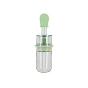 Bouteille d'huile avec brosse intégrée 18 cl Menastyl, verre transparent et silicone vert menthe, vue de face