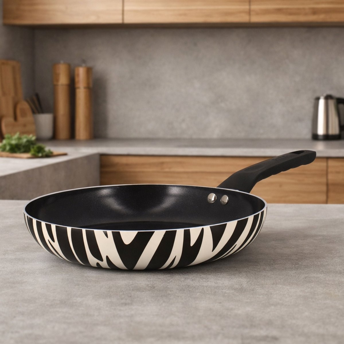 Poêle zèbre motif noir et blanc en aluminium avec revêtement céramique sans PFAS, posée sur plan de travail gris