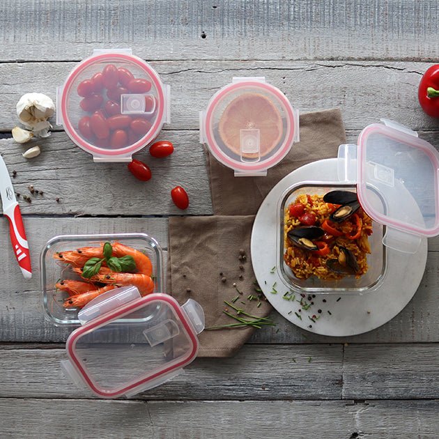 Set de boîtes hermétiques Clémentine avec couvercles roses, disposition à plat avec aliments conservés sur table en bois